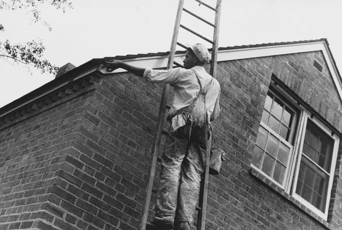 A vintage-style photograph of exterior house painting