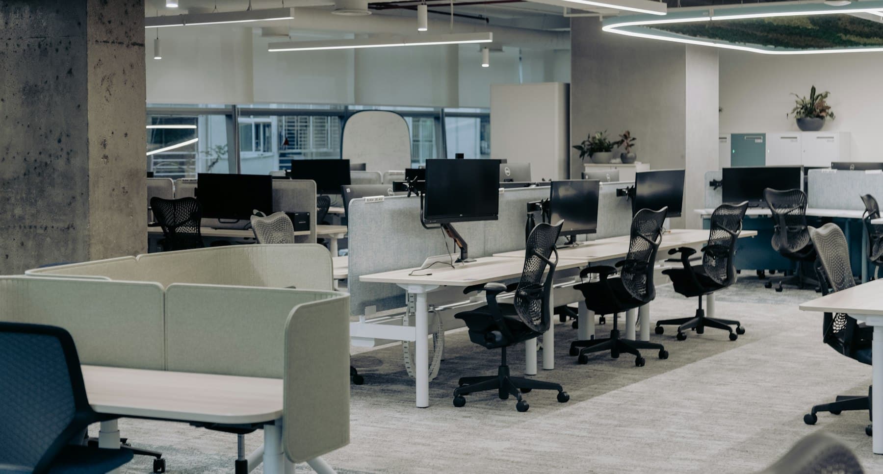 Rows of modern office workstations in a freshly finished commercial interior